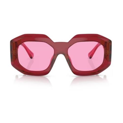 Solbriller med uregelmessig form, fuchsia linse og gjennomsiktig rød r...